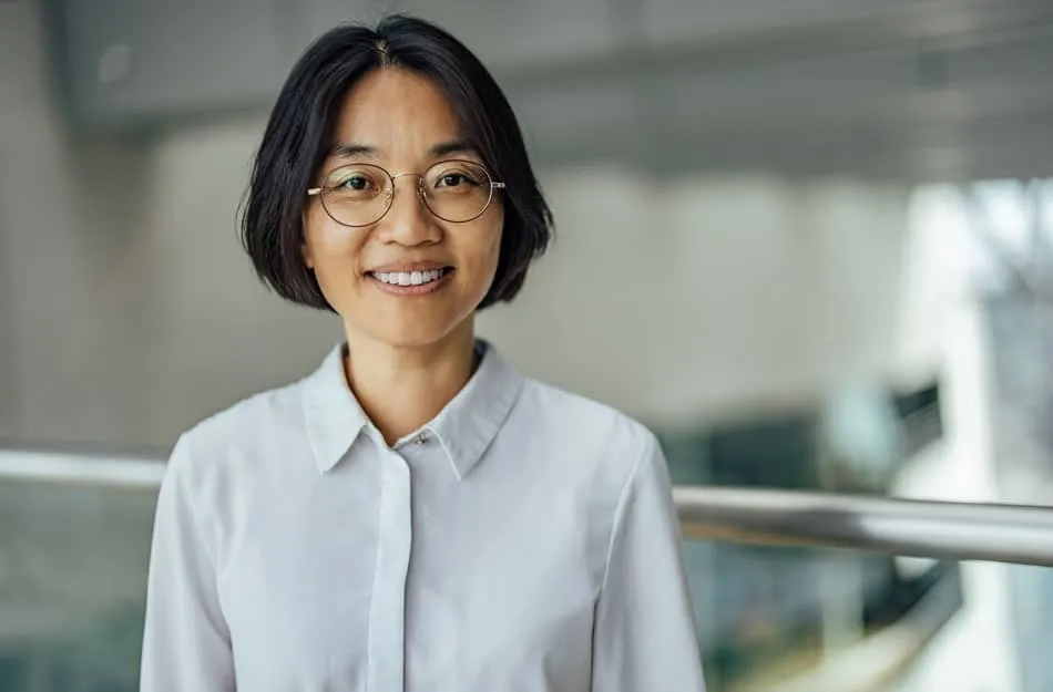 Woman in white shirt and glasses smiling